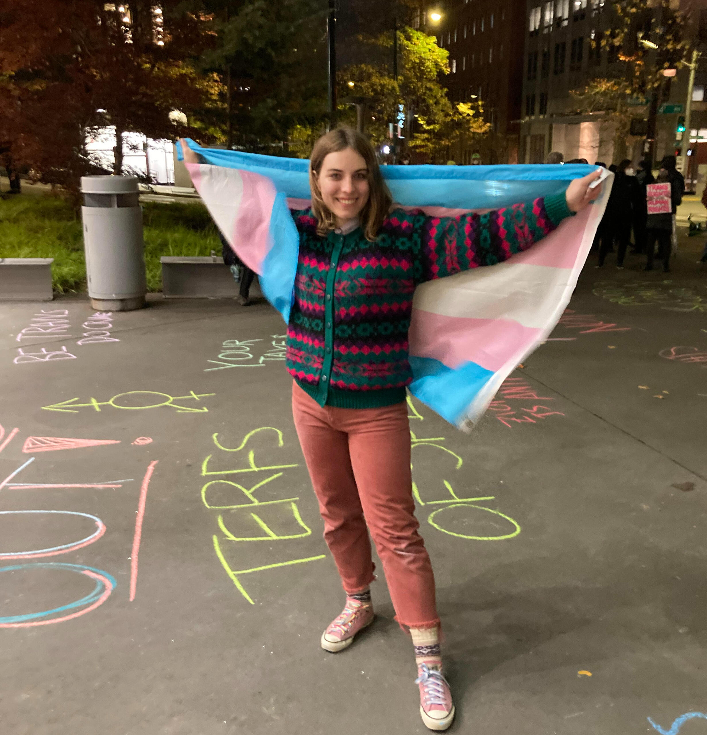 read that op-ed on page 7 of the online issue Transgender woman journalist Madison Jones holds trans pride flag at Seattle Central Library