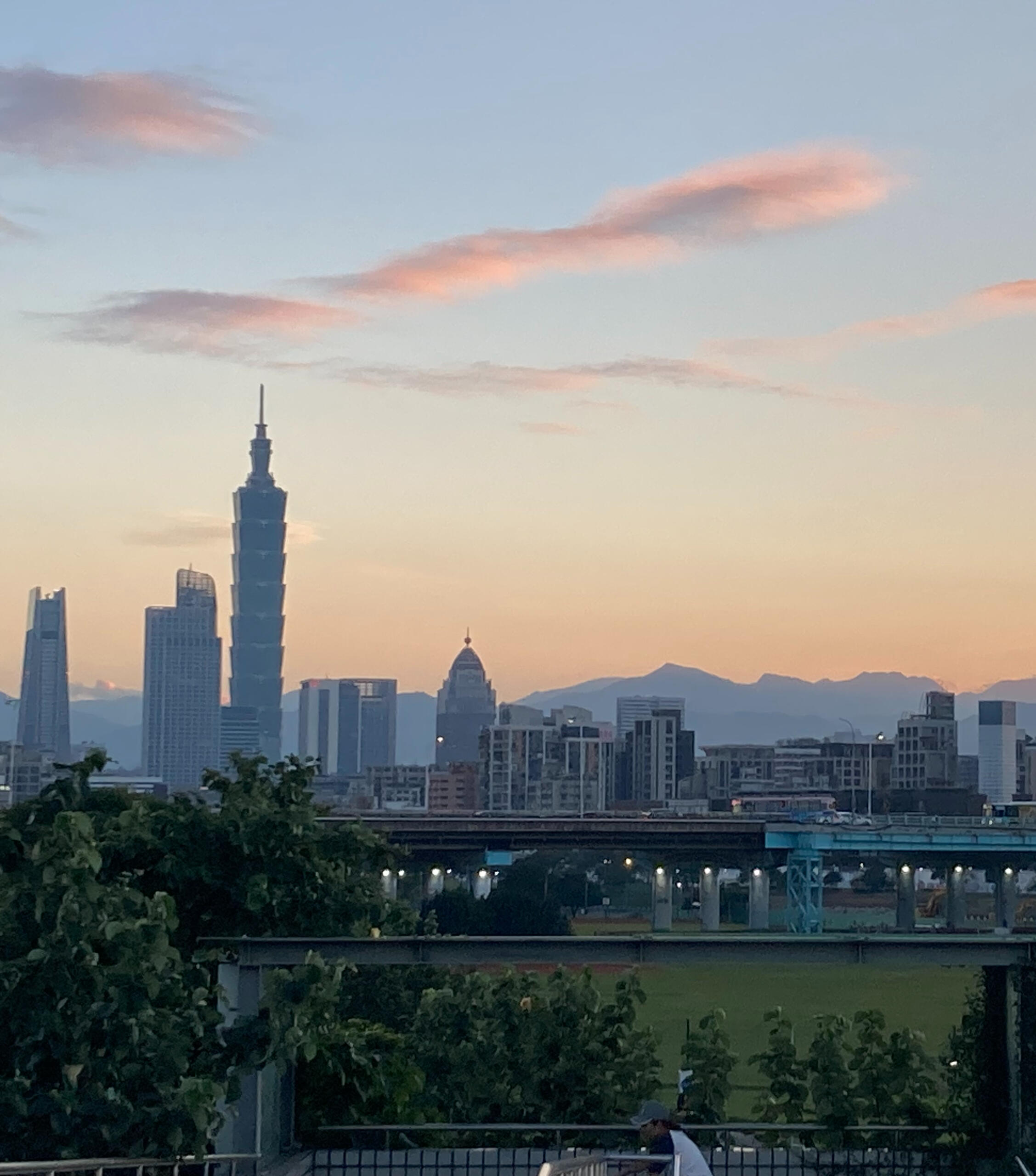 Read my love letter to Taipei here Taipei skyline with mountains blue and orange sunset
