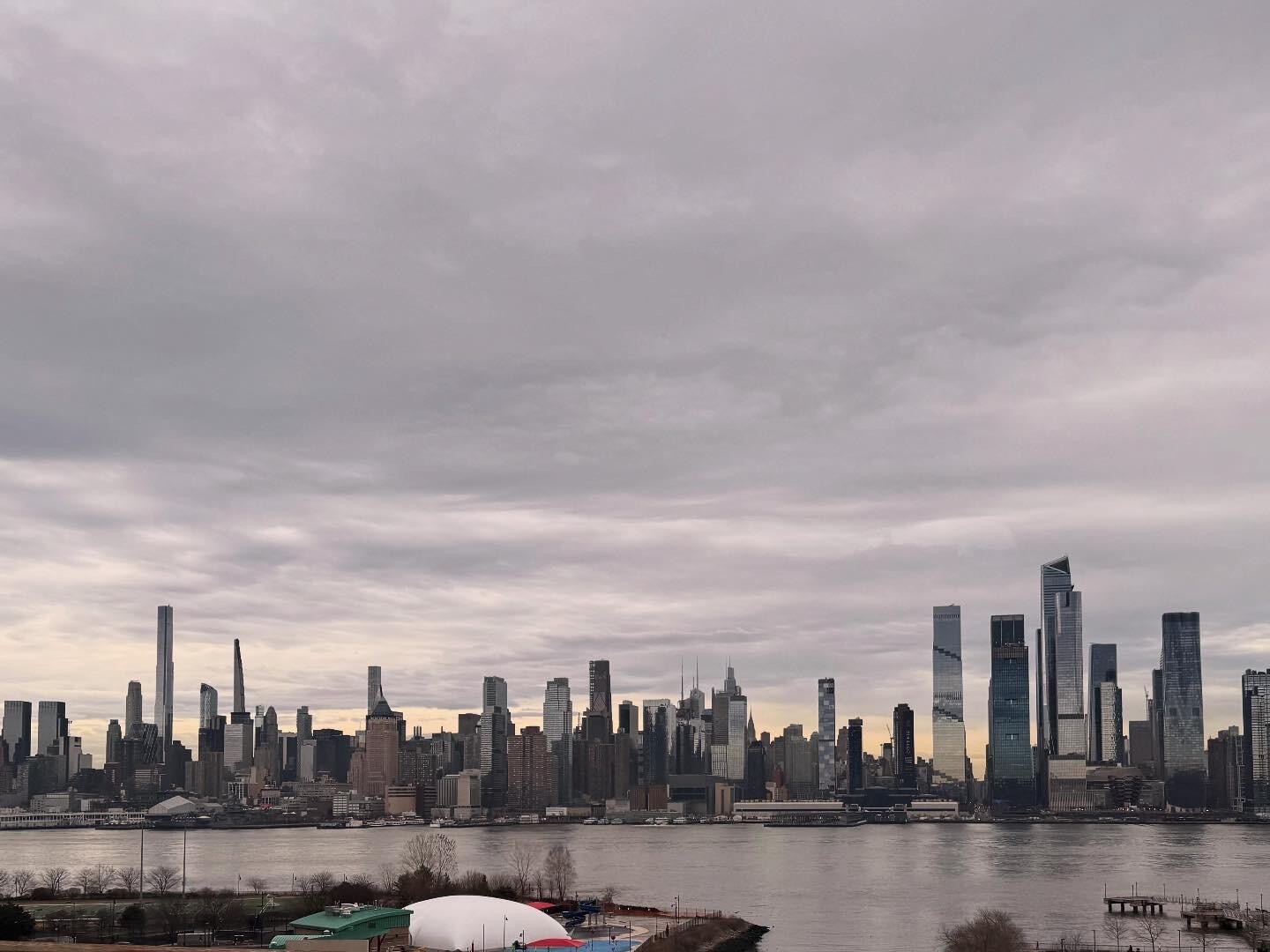 New York City Manhattan cloudy skyline East River